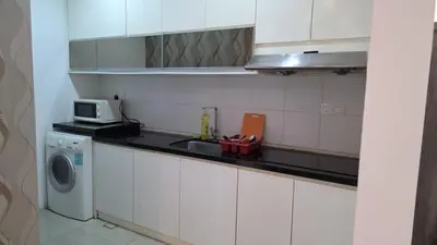 a kitchen with a sink and a washing machine at KLCC Bukit Bintang Binjai 8 premium soho by Prime Suites in Kuala Lumpur
