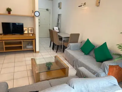 a living room with two couches and a tv at Kuala Lumpur city centre in Kuala Lumpur