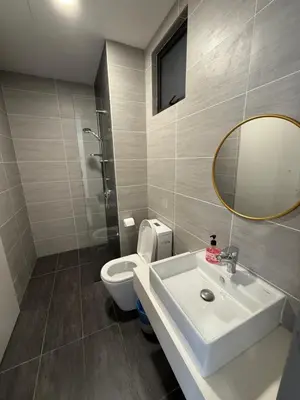 a bathroom with a sink and a toilet and a mirror at Trion Residence Kuala Lumpur By A&B in Kuala Lumpur