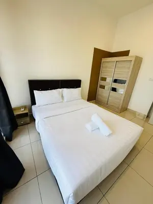a bedroom with a large white bed with two pillows at Trion Residence Kuala Lumpur By A&B in Kuala Lumpur