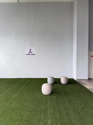 a room with a green carpet and two stools at Trion Residence Kuala Lumpur By A&B in Kuala Lumpur
