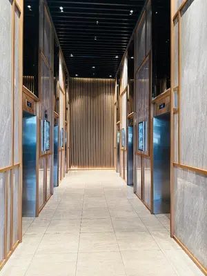 a hallway with wooden doors and a tile floor at Trion Residence Kuala Lumpur By A&B in Kuala Lumpur