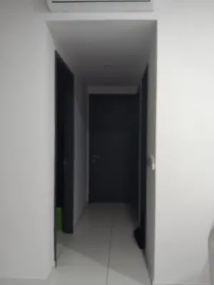 an empty hallway with a black door in a building at The Valley, SkySierra KL in Kuala Lumpur