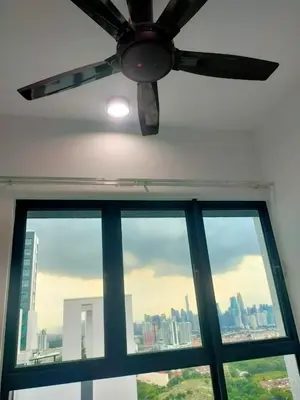 a ceiling fan in a room with a window at The Valley, SkySierra KL in Kuala Lumpur