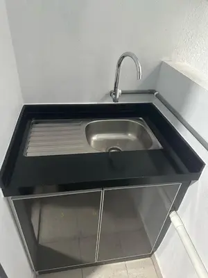 a sink with a faucet in a kitchen at The Valley, SkySierra KL in Kuala Lumpur