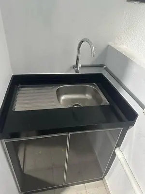 a sink with a faucet in a kitchen at The Valley, SkySierra KL in Kuala Lumpur