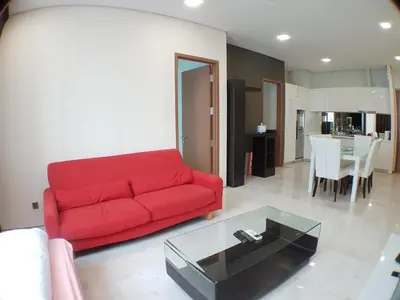a living room with a red couch and a table at Soho Suites @ KLCC by Luxury Suites Asia in Kuala Lumpur