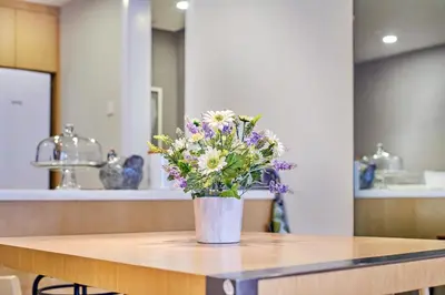 a vase of flowers sitting on top of a table at 188 Suites near KLCC with Parking and Bathtub in Kuala Lumpur