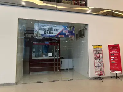 a glass doorway to a store with signs in it at Summer Suites KLCC BY Lotus in Kuala Lumpur