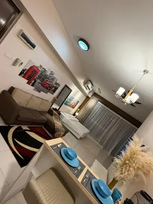 a small living room with a couch and a table at Infinity Sky Pool, Regalia Suite KLCC in Kuala Lumpur