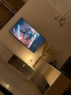 a flat screen tv hanging on a wall at Infinity Sky Pool, Regalia Suite KLCC in Kuala Lumpur