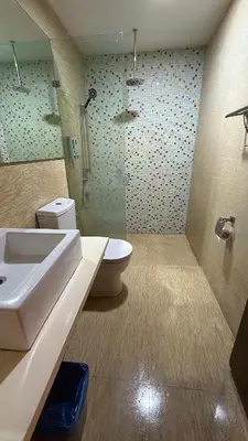 a bathroom with a sink and a toilet and a shower at Infinity Sky Pool, Regalia Suite KLCC in Kuala Lumpur