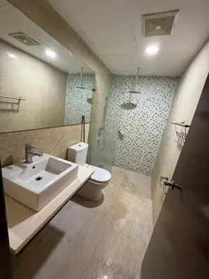 a bathroom with a sink and a toilet at Infinity Sky Pool, Regalia KLCC in Kuala Lumpur