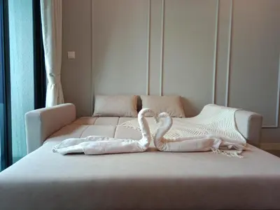 a bed with two swans made out of towels at Ooak Suites Mont Kiara Mall 163 Babycot 4 Pax in Kuala Lumpur