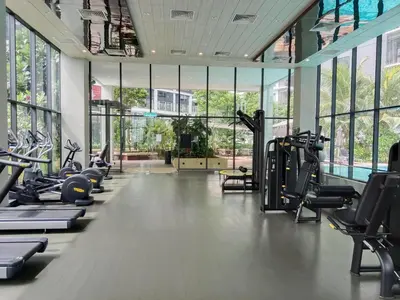 a gym with a row of treadmills and ellipticals at Ooak Suites Mont Kiara Mall 163 Babycot 4 Pax in Kuala Lumpur