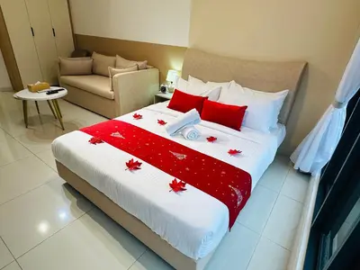 a bedroom with a large bed with red flowers on it at Majestic Residence KLCC By AMG in Kuala Lumpur