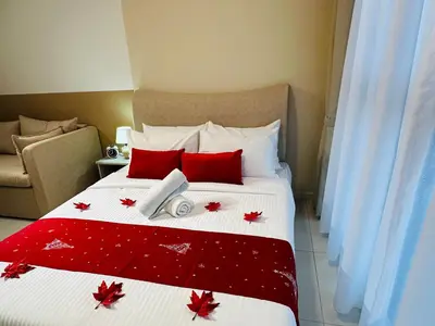 a bedroom with a bed with red leaves on it at Majestic Residence KLCC By AMG in Kuala Lumpur