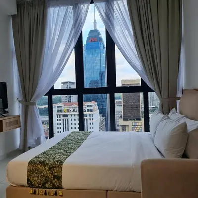 a bed in a room with a large window at Majestic Residence KLCC By AMG in Kuala Lumpur