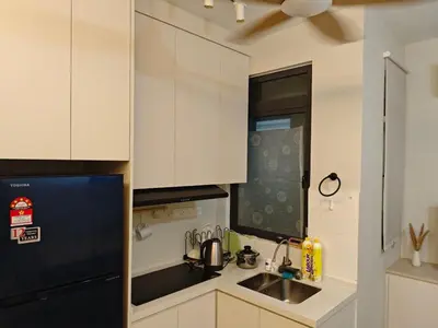 a kitchen with white cabinets and a black refrigerator at Neu Suite 2 Rooms 1 Bath Unit For Rent Free Wi-Fi Deposit RM200 in Kuala Lumpur