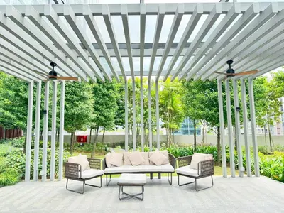 a pergola with a couch and chairs under it at Agile bukit bintang TRX by KLCC in Kuala Lumpur