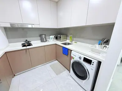 a small kitchen with a washing machine in it at Agile Bukit Bintang By AR in Kuala Lumpur