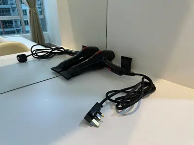 a cord plugged into an electronic device on a table at K&L Suites Razak City Kuala Lumpur in Kuala Lumpur