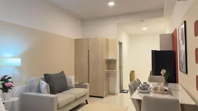 a living room with a couch and a table at Luxury studio 2607B for couple Majestic Residence KLCC in Kuala Lumpur
