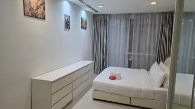 a white room with a bed and a window at KLCC Binjai 8 Premium Soho Apartment by prime suites in Kuala Lumpur