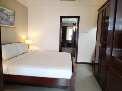 a bedroom with a large white bed in a room at KL City Tour Residence Berjaya Times Square in Kuala Lumpur