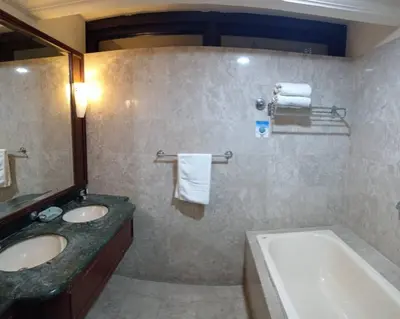 a bathroom with a tub and two sinks and a bath tub at KL City Tour Residence Berjaya Times Square in Kuala Lumpur