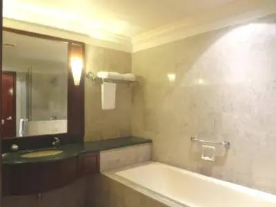 a bathroom with a tub and a sink and a mirror at KL City Tour Residence Berjaya Times Square in Kuala Lumpur