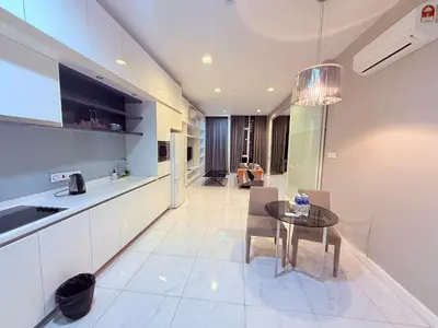 a kitchen and living room with a table and chairs at Platinum Suites Kuala Lumpur BY NOVA in Kuala Lumpur