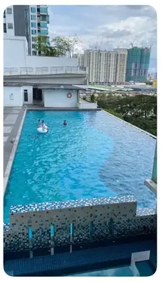 two people in a swimming pool on a building at Setapak Central Mall Bathtub & Netflix in Kuala Lumpur