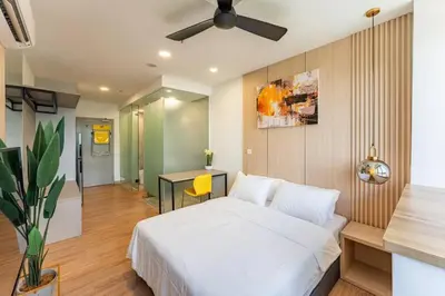 a bedroom with a white bed and a desk at Riveria city in Kuala Lumpur