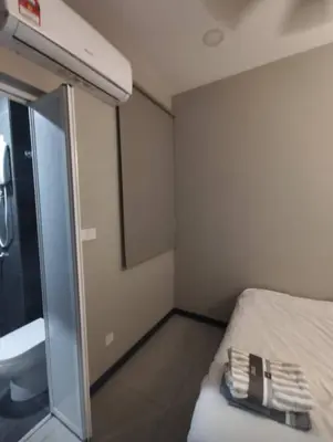 a small room with a bed and a sink at Mini studio with own private bathroom, free Wi-Fi in Kuala Lumpur
