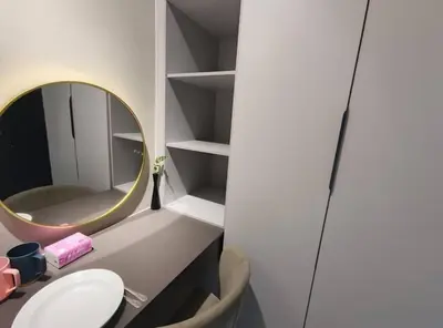 a bathroom with a round mirror and a sink at Mini studio with own private bathroom, free Wi-Fi in Kuala Lumpur