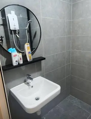 a bathroom with a sink and a mirror at Mini studio with own private bathroom, free Wi-Fi in Kuala Lumpur