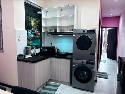 a kitchen with a washer and a washing machine at Neu suite, Family Unit - Jelatek LRT Gleneagles Hospital in Kuala Lumpur