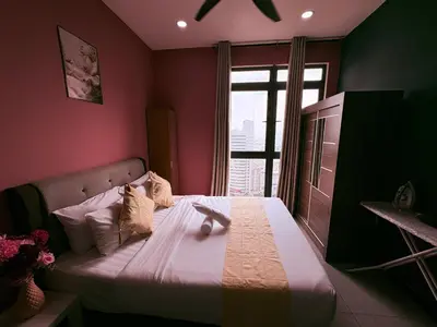 a bedroom with a large bed with a window at Neu suite, Family Unit - Jelatek LRT Gleneagles Hospital in Kuala Lumpur