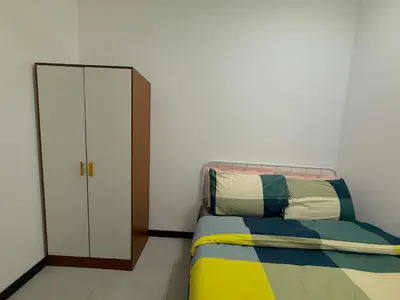 a bedroom with a bed and a mirror and a closet at Neu suite, Family Unit - Jelatek LRT Gleneagles Hospital in Kuala Lumpur
