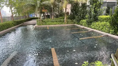 a pool of water in a garden with trees at 1-4pax, Spacious Studio, Jalan Ipoh KL The Pano in Kuala Lumpur
