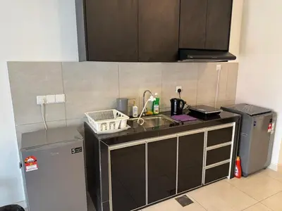 a small kitchen with a sink and a refrigerator at 1-4pax, Spacious Studio, Jalan Ipoh KL The Pano in Kuala Lumpur