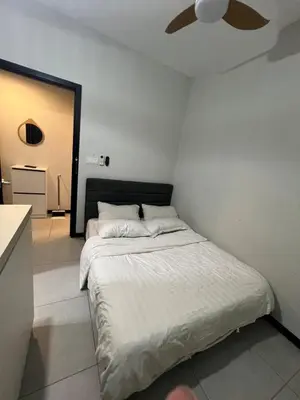 a bedroom with a bed and a ceiling fan at Neu Suite small studio with own private bathroom free wifi Deposit RM200 in Kuala Lumpur