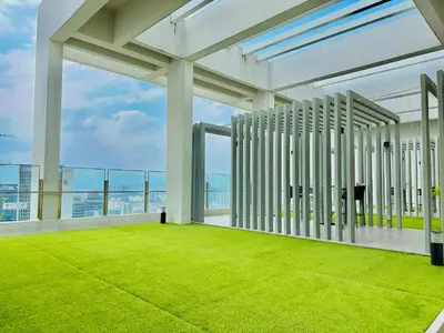 a large white building with a green lawn at Sky Line Agile Suites KL in Kuala Lumpur