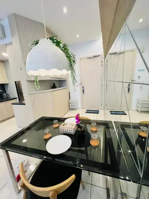 a dining room with a glass table and chairs at FA Suits KL BY ROBERTSON in Kuala Lumpur