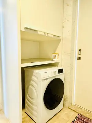 a washer and dryer in a small kitchen at The platinum KLCC by suites hospitality in Kuala Lumpur