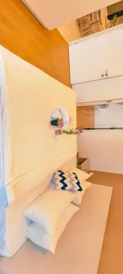 a room with a bed with white walls and pillows at The platinum KLCC by suites hospitality in Kuala Lumpur