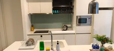 a small kitchen with a sink and a microwave at The platinum KLCC by suites hospitality in Kuala Lumpur