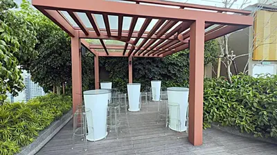 a pergola with chairs and tables on a deck at Majestic Residence Suites KLCC in Kuala Lumpur