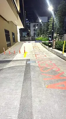 a street with orange cones and a sign on the ground at Majestic Residence Suites KLCC in Kuala Lumpur